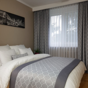 1. Musterzimmer im Hotel SKY001. Vorhänge, ein Vorhang, ein Durchgang für ein Bett und ein Kissenbezug